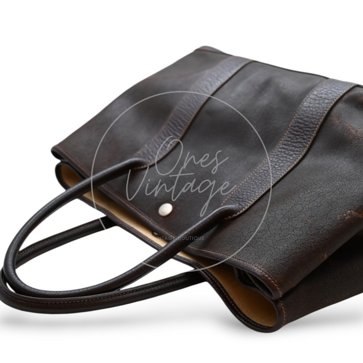 Hermès Garden Party 36 Amazon tote in dark brown rubber with leather trim, opposite angled view highlighting the rubber body