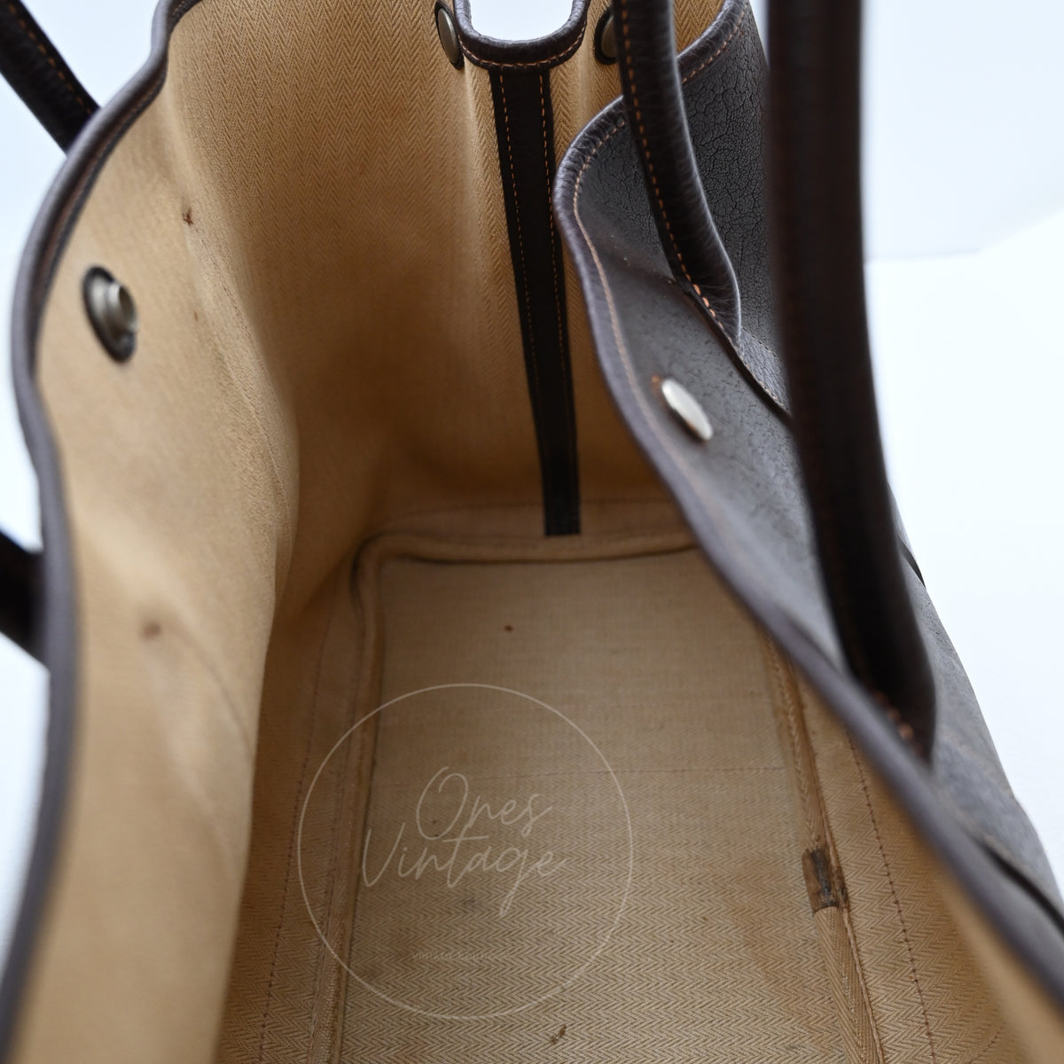 Hermès Garden Party 36 Amazon tote in dark brown rubber with leather trim, wide view of the beige canvas-lined compartment